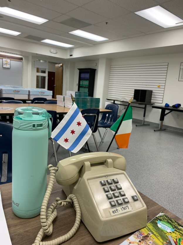 A landline telephone in a classroom.